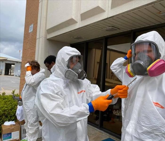 SERVPRO crew getting into PPE during a biohazard cleaning job