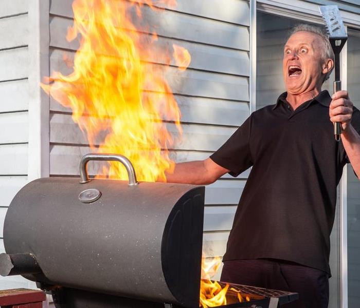 Grill on fire and man screaming