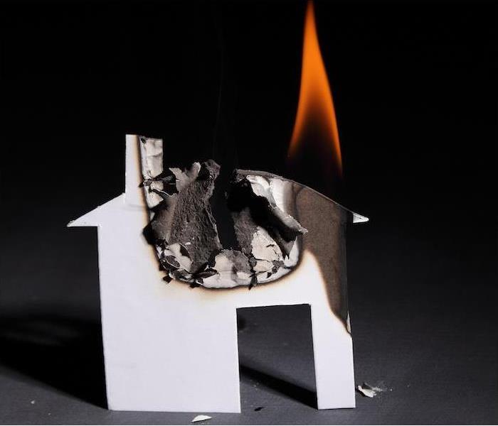 a small paper burning house